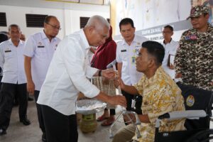 Bupati Asahan H. Surya Serahkan Bansos dan Resmikan Posko Taruna Siaga Bencana.